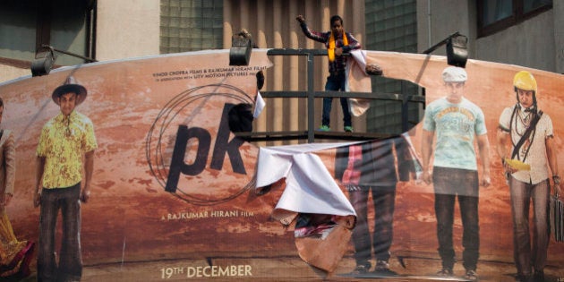 Hindu right-wing activists of the Hindu Sena tear a giant movie poster during a protest demanding a ban on the Bollywood movie