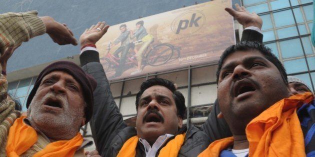 Activists from Shiv Sena, Sher-e-Punjab, shout slogans as they protest against the film 'PK' outside a cinema in Amritsar on December 23, 2014. The protest was held against the film for allegedly offending Shiv Sena religious sentiments. AFP PHOTO/ NARINDER NANU (Photo credit should read NARINDER NANU/AFP/Getty Images)