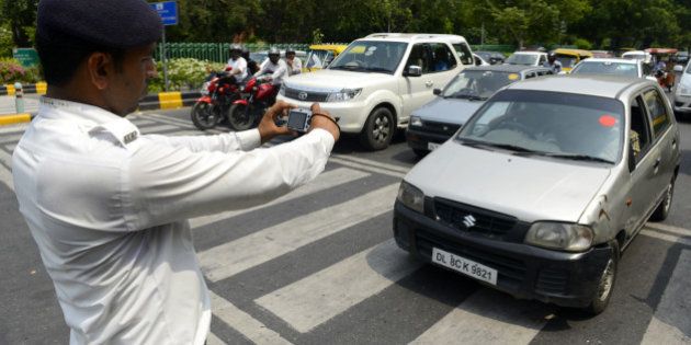 NEW DELHI, INDIA JULY 15: Delhi Police official use digital camera to nab traffic violators in New Delhi. Traffic Police issued 70 still digital cameras to its zonal officers to nab stop-line violators.(Photo by Shekhar Yadav/India Today Group/Getty Images)