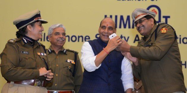 NEW DELHI, INDIA - JANUARY 1: Home minister Rajnath Singh with Delhi Police Commissioner B.S. Bassi (2L) and Special Commissioner, Delhi Police, Sundari Nanda (L) during the launch of mobile phone based application Himmat for the safety of women in the capital, on January 1, 2015 in New Delhi, India. The app will basically cater to employed women who have smartphones and travel alone even late in the night. (Photo by Vipin Kumar/Hindustan Times via Getty Images)