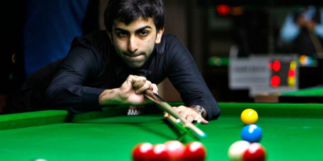 India's Pankaj Advani plays a shot during a round robin league match against Poland's Marcin Nitschke, unseen, at the International Billiards and Snooker Federation (IBSF) World Snooker Championship in Bangalore, India, Tuesday, Nov. 29, 2011. The six day event which started Monday have participants from 41 countries. (AP Photo/Aijaz Rahi)