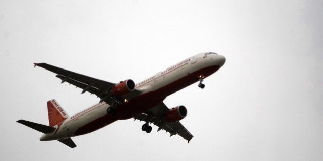 An Air India passenger jet approaches to land at Indira Gandhi International Airport in New Delhi, India, Monday, May 14, 2012. At least 300 Air India pilots walked out from their work for the past one week, leaving hundreds of passengers stranded at Delhi and Mumbai airports. Air India operates 450 international and domestic flights every day. (AP Photo/ Mustafa Quraishi)