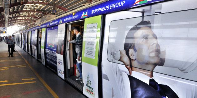 NEW DELHI, INDIA - NOVEMBER 22: The first metro train with advertisement in its exterior part will be inducted into service on November 22, 2014 in New Delhi, India. This move is aimed at augmenting its non-operational revenues. The DMRC operates a fleet of over 200 trains at present with over 60 eight-coach trains and over 80 six-coach trains whose interiors have already been made available for the purpose of advertising. (Photo by Subrata Biswas/Hindustan Times via Getty Images)
