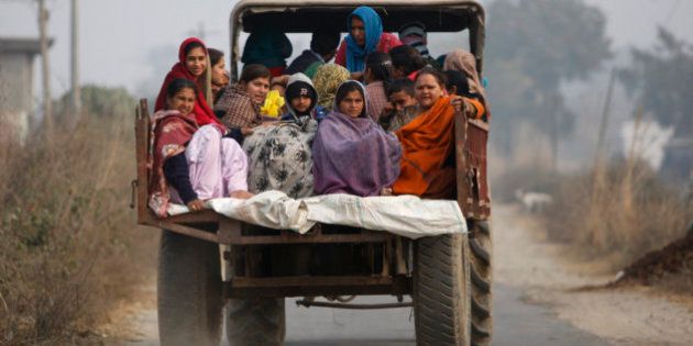 Indian villagers sit in the back of a vehicle as they flee their homes fearing firing from the Pakistan side of the border at Bainglad village in Samba sector, about 52 Kilometers from Jammu, India, Saturday, Jan. 3, 2015. Pakistani and Indian border guards traded artillery fire along the disputed border region of Kashmir, killing two people and wounding eight, officials said Saturday. Both Pakistan and India blamed each other for starting the fire that began Friday night. In India, police officer Rajesh Kumar said Pakistani shelling in the Kathua sector killed a woman and wounded seven villagers. (AP Photo/Channi Anand)