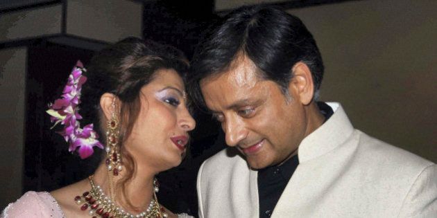 Former Indian Junior Foreign Minister Shashi Tharoor listens to his wife Sunanda Pushkar at their wedding reception in New Delhi, India, Saturday, Sept. 4, 2010. Tharoor resigned from his post earlier this year amid allegations of corruption in the bidding for an Indian premier league team at auction in April that also involved his friend and businesswoman Pushkar. (AP Photo)