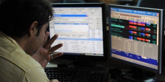 An Indian stockbroker watches his screen during intra-day trading at a brokerage house in Mumbai on September 1, 2014. The benchmark 30 share BSE index Sensex rose 262.19 points to hit new lifetime high of 26,900.30. AFP PHOTO / INDRANIL MUKHERJEE (Photo credit should read INDRANIL MUKHERJEE/AFP/Getty Images)