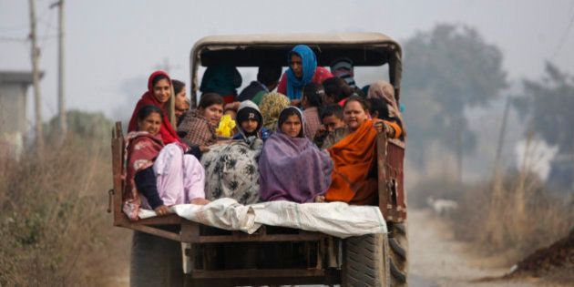 Indian villagers sit in the back of a vehicle as they flee their homes fearing firing from the Pakistan side of the border at Bainglad village in Samba sector, about 52 Kilometers from Jammu, India, Saturday, Jan. 3, 2015. Pakistani and Indian border guards traded artillery fire along the disputed border region of Kashmir, killing two people and wounding eight, officials said Saturday. Both Pakistan and India blamed each other for starting the fire that began Friday night. In India, police officer Rajesh Kumar said Pakistani shelling in the Kathua sector killed a woman and wounded seven villagers. (AP Photo/Channi Anand)