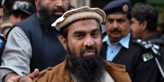 Pakistani security personnel escort Zaki-ur-Rehman Lakhvi (C), alleged mastermind of the 2008 Mumbai attacks, leaves the court after a hearing in Islamabad on January 1, 2015. Pakistan on January 1, approached the country's supreme court to stop the release of alleged mastermind of the 2008 Mumbai attacks whose detention order was this week suspended by a high court, a government prosecutor said. AFP PHOTO/ Aamir QURESHI (Photo credit should read AAMIR QURESHI/AFP/Getty Images)