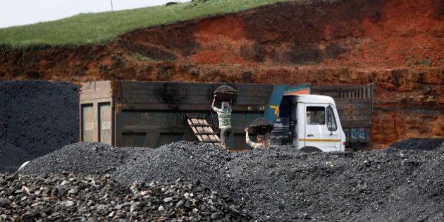 In this July 1, 2013 photo, Indian laborers load coal into a truck at a roadside coal depot at Khliehriet in Meghalaya, India. For six years, India's monopoly coal producer has missed production targets that already fall short of the countryâs demand. Industry has been left scrambling for pricier imports. Power cuts are chronic, and hundreds of millions still have no access. But what looks like a looming power crisis could actually be a rising energy transformation, with the country poised for a shift toward solar to end chronic energy woes and offer first-time access to hundreds of millions nationwide. (AP Photo/Anupam Nath)