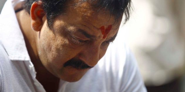 Indian Bollywood actor Sanjay Dutt, looks down during a press conference at his residence in Mumbai, India, Thursday, March 28, 2013. Dutt said he has not sought pardon for a 1993 weapons conviction and will serve his prison sentence as ordered by India's Supreme Court. Dutt broke his silence a week after the court sentenced him to five years in prison for illegal possession of weapons supplied by Mumbai crime bosses linked to a 1993 terror attack that killed 257 people.(AP Photo/Rafiq Maqbool)