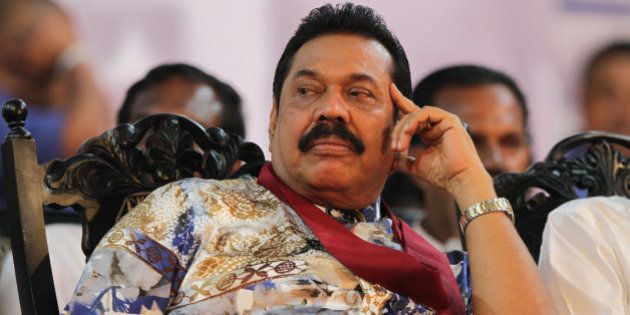 Sri Lankan President Mahinda Rajapaksa attends his final public rally for the presidential elections in Kesbewa, about 20 kilometers (12 miles) southeast of Colombo, Sri Lanka, Monday, Jan. 5, 2015. A confident Rajapaksa had called the election two years ahead of schedule, hoping to win a third six-year term before voters' memories faded of the defeat of the Tamil Tiger rebels. But an internal revolt now threatens his hold on power with Health Minister Maithripala Sirisena, a close Rajapaksa aide and No. 2 in the president's Freedom Party, defecting and announcing he would run as an opposition candidate in Thursday's election. Poster reads