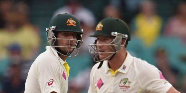 Australian batsman Joe Burns (L) and Brad Haddin (R) talk at the wicket during day four of the fourth cricket Test between Australia and India at the Sydney Cricket Ground (SCG) on January 9, 2015. AFP PHOTO/Peter PARKS --IMAGE RESTRICTED TO EDITORIAL USE - STRICTLY NO COMMERCIAL USE (Photo credit should read PETER PARKS/AFP/Getty Images)