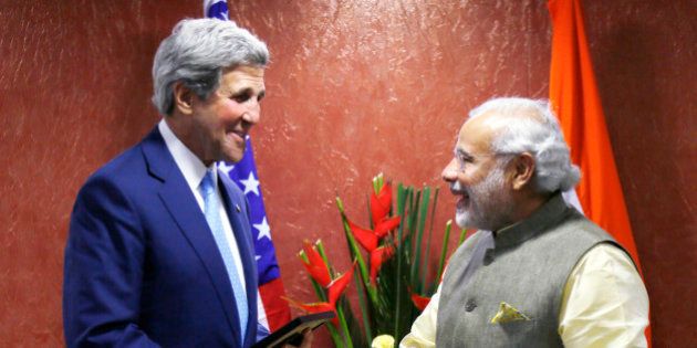 U.S. Secretary of State John Kerry, left, shakes hands with Indian Prime Minister Narendra Modi on the sidelines of the Vibrant Gujarat conference in Ahmedabad, India, Sunday, Jan. 11, 2015. Kerry is in India to attend an international investment conference and push trade ties with the giant South Asian nation ahead of visit by President Barack Obama later this month. (AP Photo/Rick Wilking, Pool)