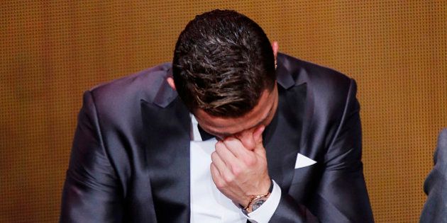 Real Madrid's Christiano Ronaldo of Portugal cries next to his son Ronaldo Junior after receiving the trophy for the world player at the FIFA Ballon d'Or 2013 Gala in Zurich, Switzerland, Monday, Jan. 13, 2014. (AP Photo/Michael Probst)