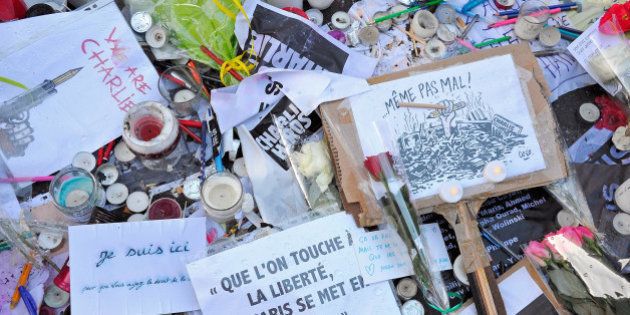 PARIS, FRANCE - JANUARY 14: Tributes of drawings, flowers, pens and candles are left near the Charlie Hebdo offices on January 14, 2015 in Paris, France. Released today, an initial three million copies of the controversial magazine Charlie Hebdo were printed in the wake of last week's terrorist attacks with an additional two million copies of the magazine scheduled to be printed. (Photo by Kristy Sparow/Getty Images)