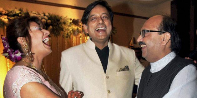 Former Indian Junior Foreign Minister Shashi Tharoor, center, and his wife Sunanda Pushkar are greeted by Indian lawmaker Amar Singh at their wedding reception in New Delhi, India, Saturday, Sept. 4, 2010. Tharoor resigned from his post earlier this year amid allegations of corruption in the bidding for an Indian premier league team at auction in April that also involved his friend and businesswoman Pushkar. (AP Photo)