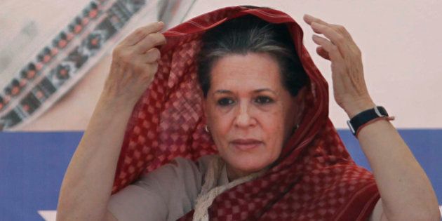 India's ruling Congress party President Sonia Gandhi adjusts the hood of her sari during an election campaign rally for the upcoming Gujarat state Assembly elections at Kalol near Ahmadabad, India, Friday, Dec. 14, 2012. The second phase of polling for the Gujarat state Assembly elections is scheduled to be held on Dec. 17. (AP Photo/Ajit Solanki)