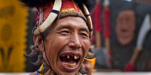 A Naga tribal man in traditional attire laughs as he waits to perform a dance during the Hornbill festival at the Kisama village in Nagaland, India, Tuesday, Dec. 2, 2014. The 10-day long festival named after the Hornbill bird is one of the biggest festivals of Indiaâs northeast that showcases the rich tradition and cultural heritage of the indigenous Nagas. (AP Photo/Anupam Nath)