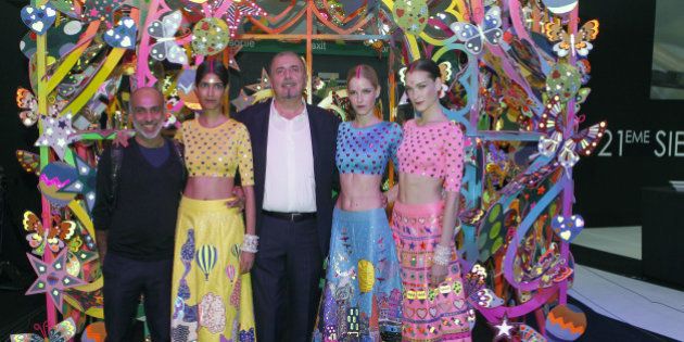 PARIS, FRANCE - OCTOBER 02: Indian designer Manish Arora and Alcantara CEO, Andrea Boragno poses with models in a fantasy house titled 'Life is Beautiful' created by Manish Arora after a fashion show during the Paris Motor Show on October 02, 2014 in Paris, France. Alcantara CEO, Andrea Boragno has set up an exceptional collaboration with Manish Arora. (Photo by Chesnot/Getty Images)