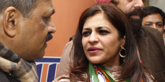 NEW DELHI, INDIA - JANUARY 16: BJP Delhi Pradesh President Satish Upadhyay with former AAP leader Shazia Ilmi after she joined BJP at party office on January 16, 2015 in New Delhi, India. Ilmi had contested and narrowly lost the December 2013 assembly elections on AAP ticket. AAP also fielded her in the Lok Sabha elections of 2014 from Ghaziabad in Uttar Pradesh where she finished a distant fifth. Polling in Delhi will be held on February 7 and the counting of votes will take place on February 10. (Photo by Arvind Yadav/Hindustan Times via Getty Images)