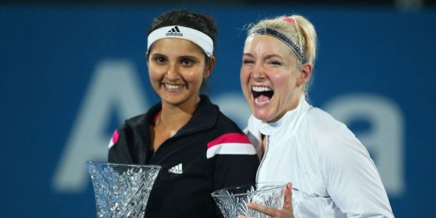 SYDNEY, AUSTRALIA - JANUARY 16: Bethanie Mattek-Sands of the USA and Sania Mirza of India pose with the trophy after victory in Women's Doubles Final Match against Raquel Kops-Jones and Abigail Spears of the USA during day six of the 2015 Sydney International at Sydney Olympic Park Tennis Centre on January 16, 2015 in Sydney, Australia. (Photo by Brendon Thorne/Getty Images)