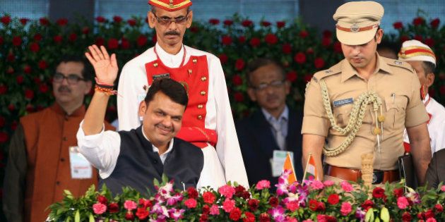 Devendra Fadnavis waves to the crowd after being sworn in as chief minister of Maharashtra state in Mumbai, India, Friday, Oct. 31, 2014. Fadnavis was sworn in as chief minister of the first Bharatiya Janata Party (BJP) government in the state. (AP Photo/Rajanish Kakade)