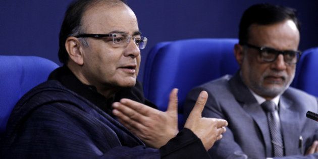 NEW DELHI, INDIA - JANUARY 20: Union Finance Minister Arun Jaitley and Financial Services Secretary Hasmukh Adhia () during the Press conference at Shastri Bhawan on January 20, 2015 in New Delhi, India. As many as 11.5 crore bank accounts have been opened under the Pradhan Mantri Jan Dhan Yojana, exceeding the enhanced target of 10 crore and covering 99.74 per cent of households. A Guinness Book World record has been created for most bank accounts opened in one week as part of the Financial Inclusion Campaign is 18,096,130 and was achieved by the Department of Financial Services, Government of India from August 23 to 29, 2014. (Photo by Virendra Singh Gosain/Hindustan Times via Getty Images)