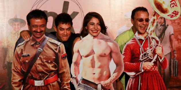 Bollywood Director Rajkumar Hirani, left, Bollywood actors Aamir Khan, second left, Anushka Sharma, second right, and producer Vidhu Vinod Chopra pose in front of movie character cut-outs during the teaser launch of their upcoming film