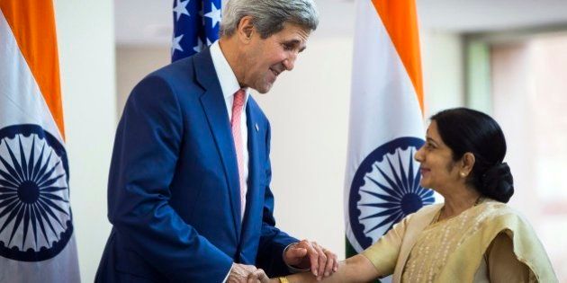 U.S. Secretary of State John Kerry greets Indian Foreign Minister Sushma Swaraj in New Delhi, India, Thursday, July 31, 2014. This is Kerry's first visit to India following the resounding election win of Prime Minister Narendra Modi in May. (AP Photo/Lucas Jackson, Pool)
