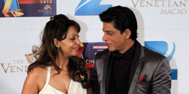 In this Saturday, Jan. 21, 2012, file photo, Indian Bollywood superstar Shah Rukh Khan, right, poses with his wife, Gauri, on the red carpet of the Zee Cine Awards 2012 in Macau. Health officials in Mumbai are investigating reports that actor Khan has found out the sex of a child he is having through a surrogate mother. Sex determination tests are banned in India to stop the practice of aborting female fetuses due to a preference for sons. (AP Photo/Kin Cheung, File)