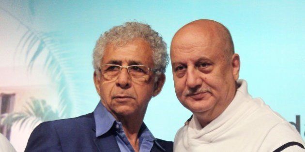 Indian Bollywood film actors Naseeruddin Shah (L) and Anupam Kher pose during the book launch of 'Witnessing Wonders' by journalist Ali Peter John, organized by the Hridayesh Arts in Mumbai on December 28, 2014. AFP PHOTO (Photo credit should read STR/AFP/Getty Images)