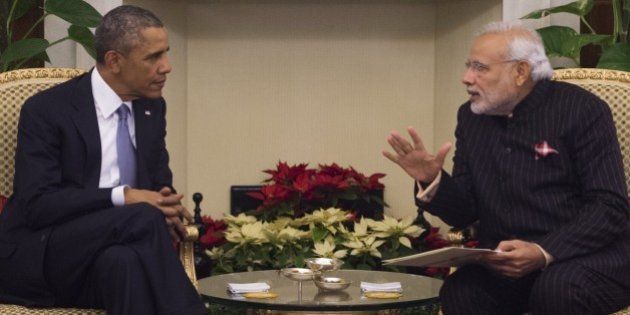 Indian Prime Minister Narendra Modi (R) and US President Barack Obama talk during a meeting at Hyderabad House in New Delhi on January 25, 2015. US President Barack Obama held talks January 25 with Prime Minister Narendra Modi at the start of a three-day India visit aimed at consolidating increasingly close ties between the world's two largest democracies. The two leaders sat down for a working lunch in central Delhi after sharing a bear hug at the airport where Modi, dressed in a bright saffron shawl, broke with protocol to greet the first couple on the tarmac. AFP PHOTO / SAUL LOEB (Photo credit should read SAUL LOEB/AFP/Getty Images)