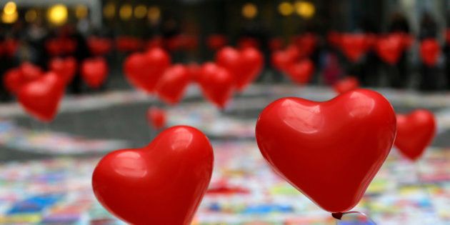 Heart-shaped balloons float as part of an exhibition for children suffering heart diseases in Milan, Italy, Saturday, Dec. 13, 2014. (AP Photo/Antonio Calanni)