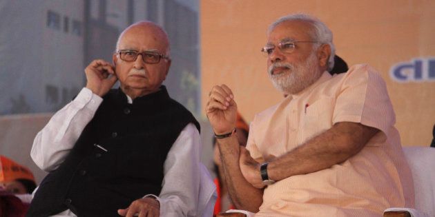 Gujarat state chief minister and Bharatiya Janata Party's prime ministerial candidate Narendra Modi, right, and senior leader Lal Krishna Advani sit during party workers convention after inaugurating the party's new state headquarters building in Gandhinagar, India, Monday, Feb. 10, 2014. (AP Photo/Ajit Solanki)