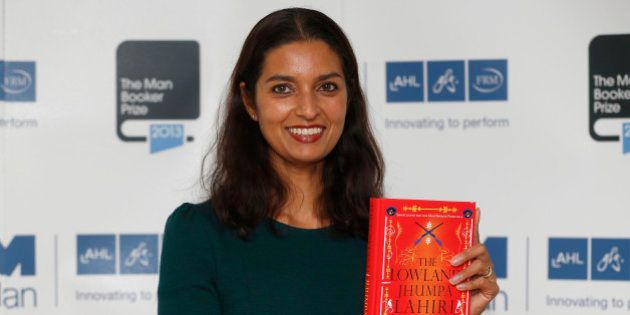 FILE - In this Oct. 13, 2013 file photo, author Jhumpa Lahiri poses with her book 'The Lowland' in London. Lahiri, Thomas Pynchon, and George Saunders were among the finalists Wednesday, Oct. 16, 2013 for the National Book Awards. A month after releasing long-lists of 10 in each of the four competitive categories, the National Book Foundation announced the five remaining writers for fiction, nonfiction, poetry and young people's literature. Winners receive $10,000 and will be announced at a dinner ceremony in Manhattan on Nov. 20. (AP Photo/Sang Tan)