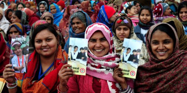 PANIPAT, INDIA - JANUARY 22: Ladies in crowd holding brochures at launch of Beti Bachao Beti Padhao programme on January 22, 2015 in Panipat, India. The Beti Bachao Beti Padhao campaign, which means Save the girl child, educate the girl child, aims to address the issue of declining Child Sex Ratio (CSR) through a mass campaign across the country targeted at changing societal mindsets and creating awareness about the criticality of the issue. (Photo by Ravi Kumar/Hindustan Times via Getty Images)