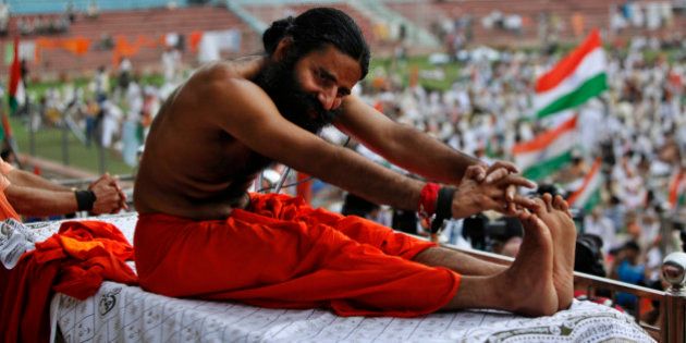 Indian yoga guru Baba Ramdev stretches during an anti-corruption protest in New Delhi, India, Tuesday, Aug. 14, 2012. Ramdev sipped a glass of fruit juice offered by supporters ending his hunger strike Tuesday but said his battle against endemic corruption in India will continue. (AP Photo/Rajesh Kumar Singh)