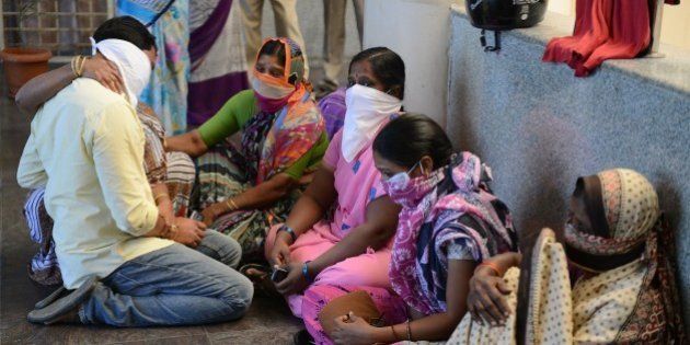 Family members of Indian swine flu patients wait outside the ward at the Gandhi Hospital in Hyderabad on January 21, 2015. Seven swine flu deaths have been recorded since January and more than 100 positive cases in the southern Indian state of Telangana, a report said. AFP PHOTO / Noah SEELAM (Photo credit should read NOAH SEELAM/AFP/Getty Images)