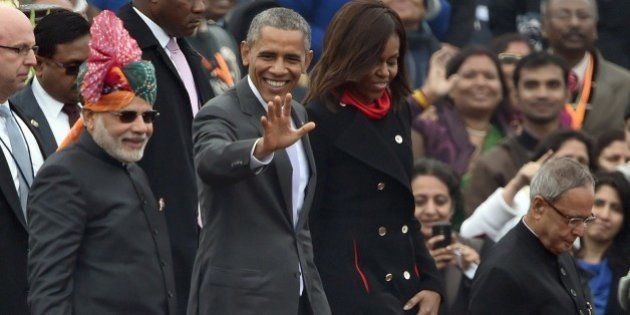 US President Barack Obama (2L) waves to spectators as he leaves with US First Lady Michelle Obama (2R), Indian Prime Minister Narendra Modi (L) and Indian President Pranab Mukherjee (R) after attending India's Republic Day parade on Rajpath in New Delhi on January 26, 2015. Rain failed to dampen spirits at India's Republic Day parade January 26 as Barack Obama became the first US president to attend the spectacular military and cultural display in a mark of the nations' growing closeness. AFP PHOTO/ PRAKASH SINGH (Photo credit should read PRAKASH SINGH/AFP/Getty Images)