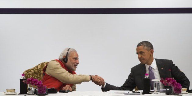 Indian Prime Minister Narendra Modi and US President Barack Obama shake hands during the India-US Business Summit in New Delhi on January 26, 2015. Rain failed to dampen spirits at India's Republic Day parade January 26 as Barack Obama became the first US president to attend the spectacular military and cultural display in a sign of the nations' growing closeness. AFP PHOTO / SAUL LOEB (Photo credit should read SAUL LOEB/AFP/Getty Images)
