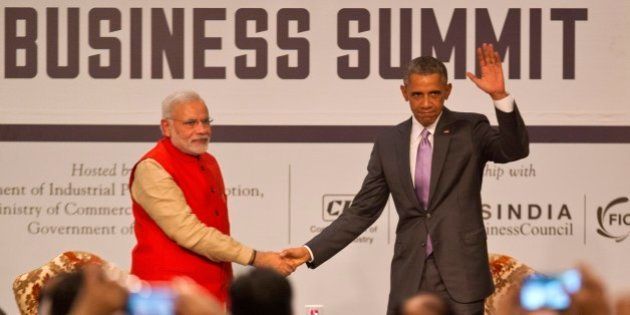 U.S. President Barack Obama, right waves to the audience as he and Indian Prime Minister Narendra Modi attend the India-U.S business summit in New Delhi, India, Monday, Jan. 26, 2015. Obama urged business leaders to find ways to seize the