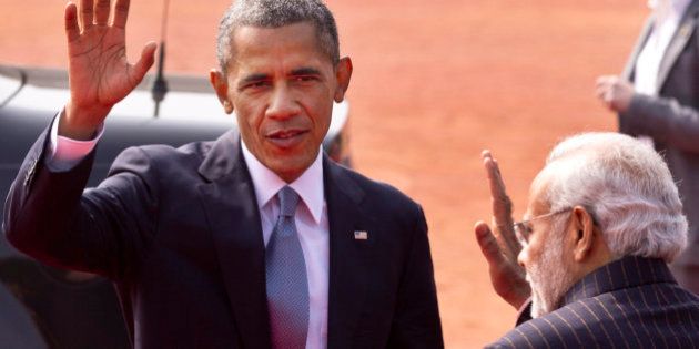 U.S. President Barack Obama waves to the media, with Indian Prime Minister Narendra Modi standing beside him during a ceremonial reception at the Indian Presidential Palace in New Delhi, India, Sunday, Jan. 25, 2015. Obama is the first American leader to be invited to attend India's Republic Day festivities, which commence Monday and mark the anniversary of the enactment of the country's democratic constitution. (AP Photo/Saurabh Das)
