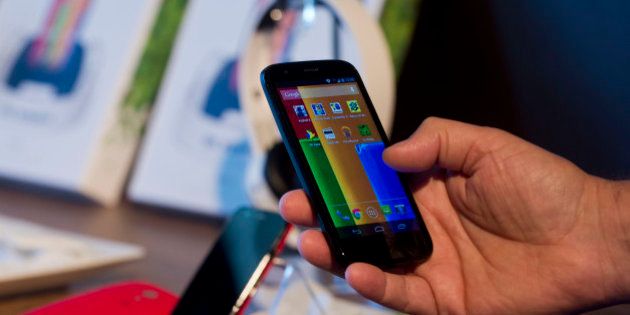 The new low cost smartphone of Motorola, 'Motorola Moto G', is displayed in Sao Paulo, Brazil on November 13, 2013. The smartphone, with dimensions 65.9mm W x 129.9mm H x 6.0 - 11.6mm D is equipped with a Qualcomm Snapdragon 400 with quad-core 1,2 GHz CPU, a 4.5-inch display and Android Operating System 4.3 and a suggested price of $ 179 USD. AFP PHOTO / NELSON ALMEIDA (Photo credit should read NELSON ALMEIDA/AFP/Getty Images)