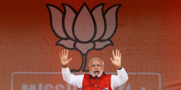 Indian Prime Minister Narendra Modi addresses an election campaign rally in Kathua, about 90 kilometers from Jammu, India, Saturday, Dec.13, 2014. The final two phases of the five-phased state elections of Jammu and Kashmir will be held on Dec. 14 and 20. (AP Photo/Channi Anand)