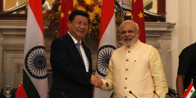 NEW DELHI, INDIA - SEPTEMBER 18: Prime Minister Narendra Modi and Chinese President Xi Jinping shake hands at the agreement signing ceremony at Hyderabad House on September 18, 2014 in New Delhi, India. India and China inked 12 pacts in a range of areas including railways and outer space as Beijing pledged investments of USD 20 billion over five years in a bid to boost economic ties and address Indias concerns over trade deficit. (Photo by Arvind Yadav/Hindustan Times via Getty Images)