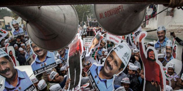 Aam Aadmi Party (AAP), or Common Man's Party supporters carry portraits of party chief Arvind Kerjiwal during a road show ahead of filing his nomination papers for the Delhi state elections in New Delhi, India, Tuesday, Jan. 20, 2015. Delhi elections begins on February 7. (AP Photo/Tsering Topgyal)