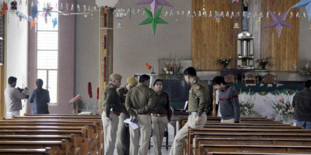 NEW DELHI, INDIA - FEBRUARY 2: Delhi Police officers investigate after attack on St Alphonsas church at Vasant Kunj on February 2, 2015 in New Delhi, India. The fifth attack on a church since December comes just five days before assembly elections. (Photo by Sonu Mehta/Hindustan Times via Getty Images)