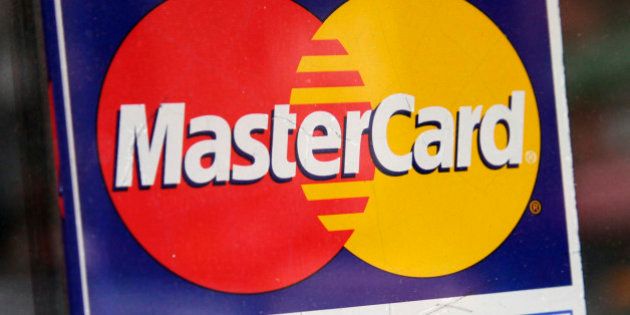 In this Jan. 21, 2015 photo, a sign indicating MasterCard credit cards are accepted is posted at a New York business. MasterCard on Friday, Jan. 30, 2015, reported fourth-quarter profit of $801 million. (AP Photo/Mark Lennihan)