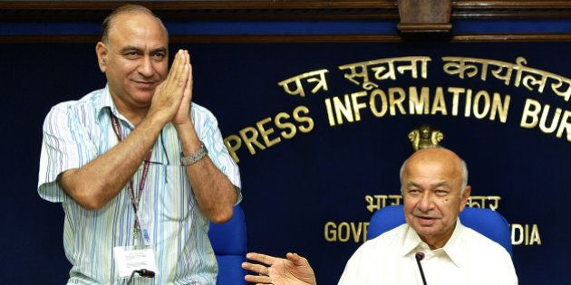 NEW DELHI, INDIA - AUGUST 1: Union Home Minister Sushilkumar Shinde with the new Home Secretary Anil Goswami (L) at the monthly press conference of their ministry at Shastri Bhawan on August 1, 2013 in New Delhi, India. 72-year-old Shinde, who became the country's Home Minister on July 31 last year succeeding P Chidambaram suggested he was a good team leader and he takes criticism in his stride. (Photo by Sonu Mehta/Hindustan Times via Getty Images)