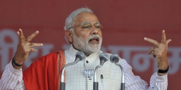 NEW DELHI, INDIA FEBRUARY 4: Prime Minister Narendra Modi addressing an election rally at Ambedkar Nagar for the upcoming Delhi Assembly Elections on February 4, 2015 in New Delhi, India. The elections for the 70-member Delhi assembly will be held in a single phase on February 7. The counting of votes will take place on February 10. The last day of campaigning is February 5. (Photo by Vipin Kumar/Hindustan Times via Getty Images)